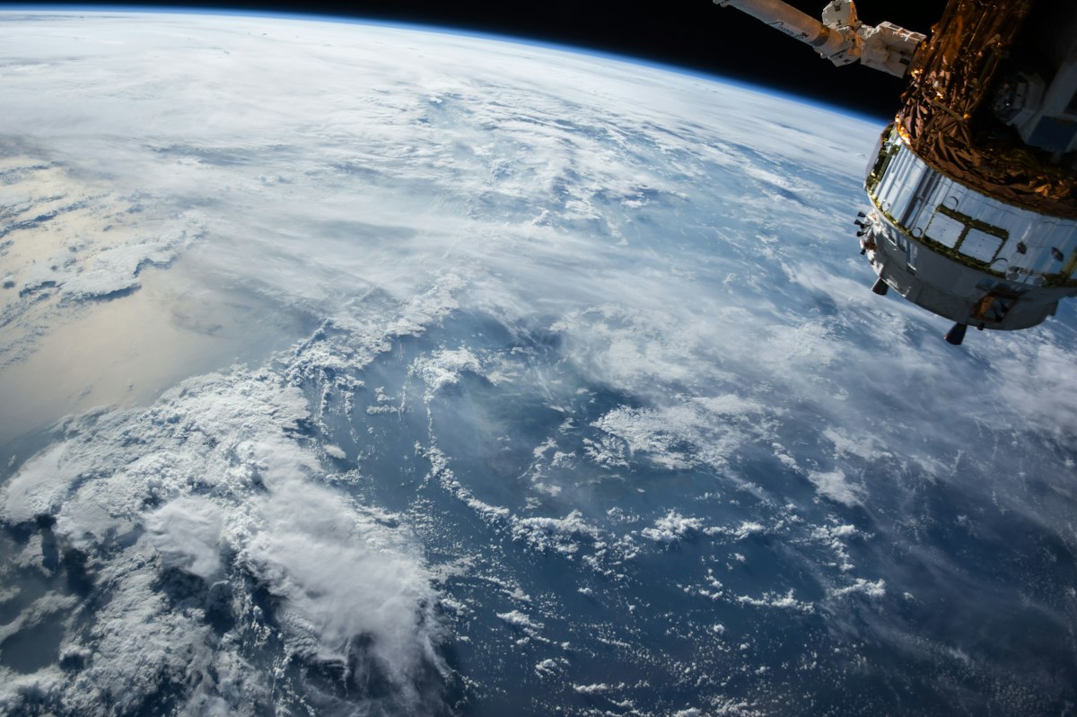 Earth ringed by a constellation of satellites.